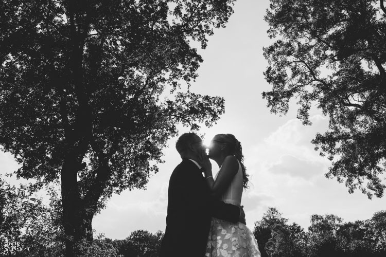 Silhouette of wedding couple kissing
